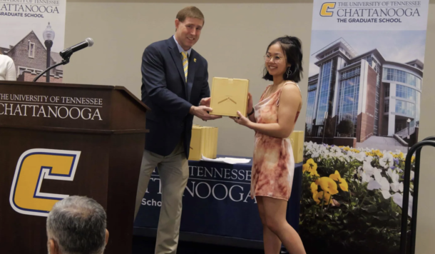 Andrea Stevens receives the Outstanding Master’s Student Award for the Chemical Engineering graduate program from Dr. Ethan Carver, associate provost and dean of the Graduate School.
